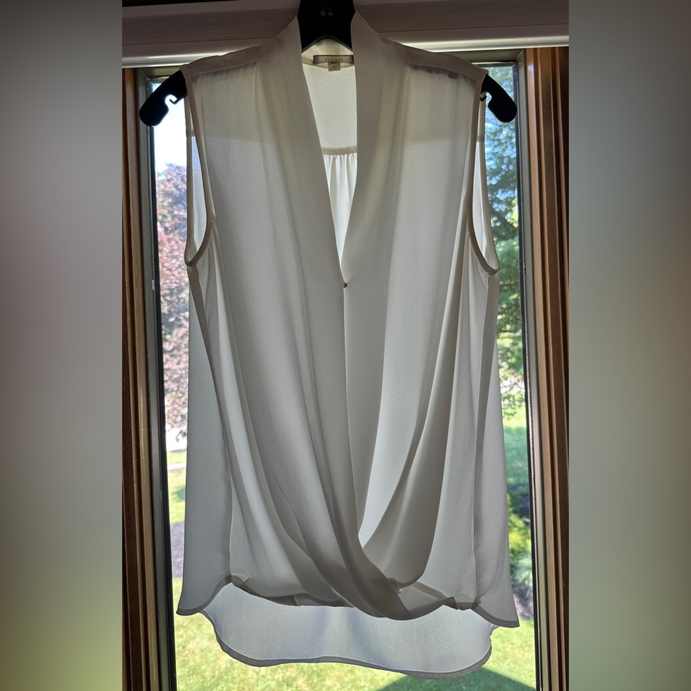 Pleione sheer white sleeveless blouse. V-neckline & hidden snap.